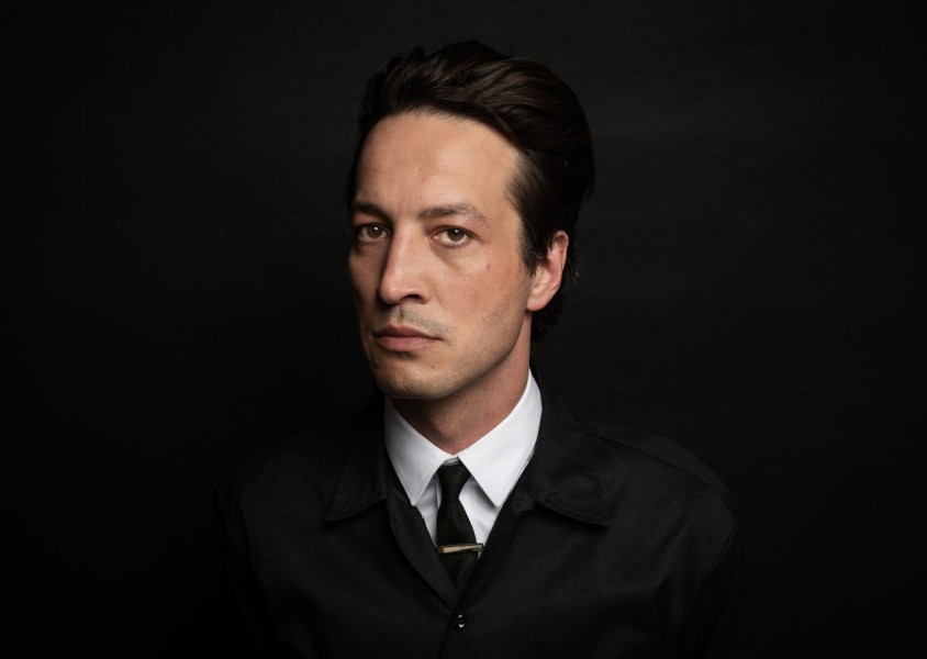 Marlon Williams in a black suitx